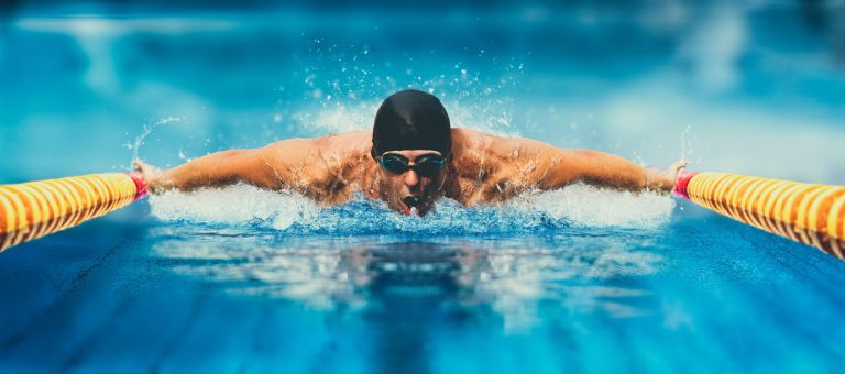 Swimmer in the middle of a session at a training camp in an Olympic-size pool